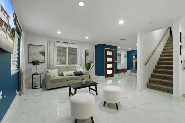 a living room with furniture and a large window