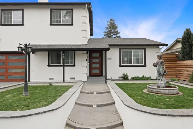 a front view of a house with garden