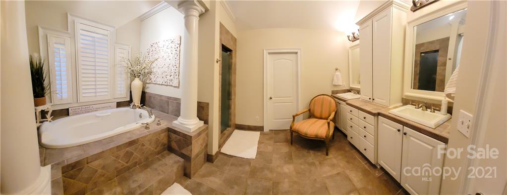140 Rocky River Road Mooresville, NC 28115 - Photo 22 of 32 a en suite spacious bathroom with a granite countertop double vanity sink and a bathtub