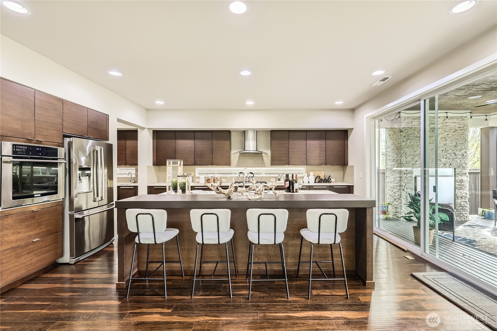 3702 170th Place Southeast Bothell, WA 98012 - Photo 16 of 40 a kitchen with stainless steel appliances granite countertop a stove a sink a refrigerator white cabinets and wooden floor