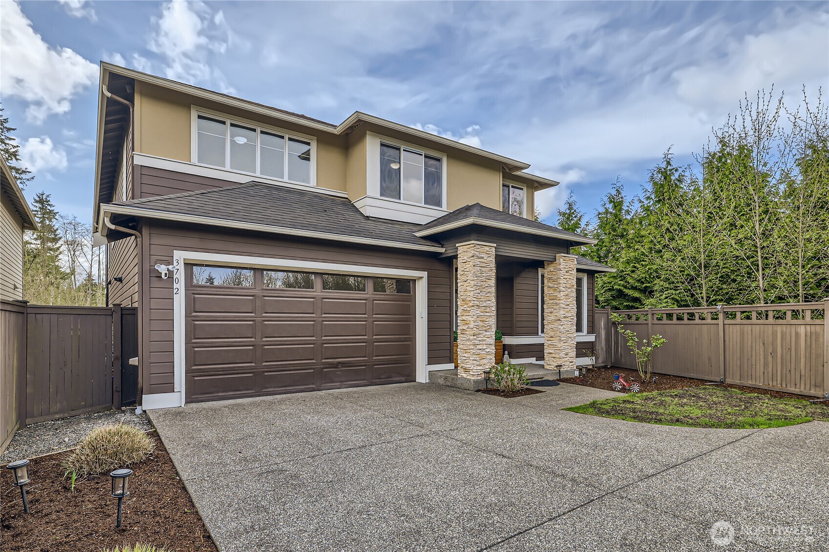 3702 170th Place Southeast Bothell, WA 98012 - Photo 2 of 40 a front view of a house with a yard and garage