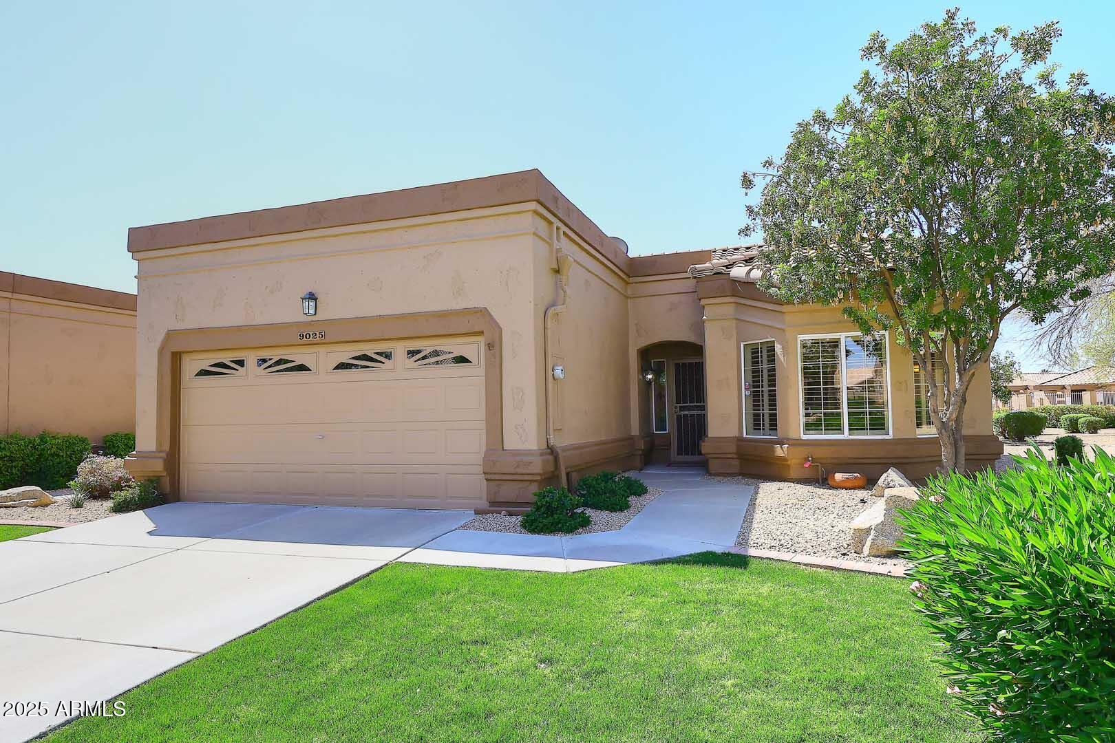 9025 West Marco Polo Road Peoria, AZ 85382 - Photo 2 of 38 a front view of house with yard and green space