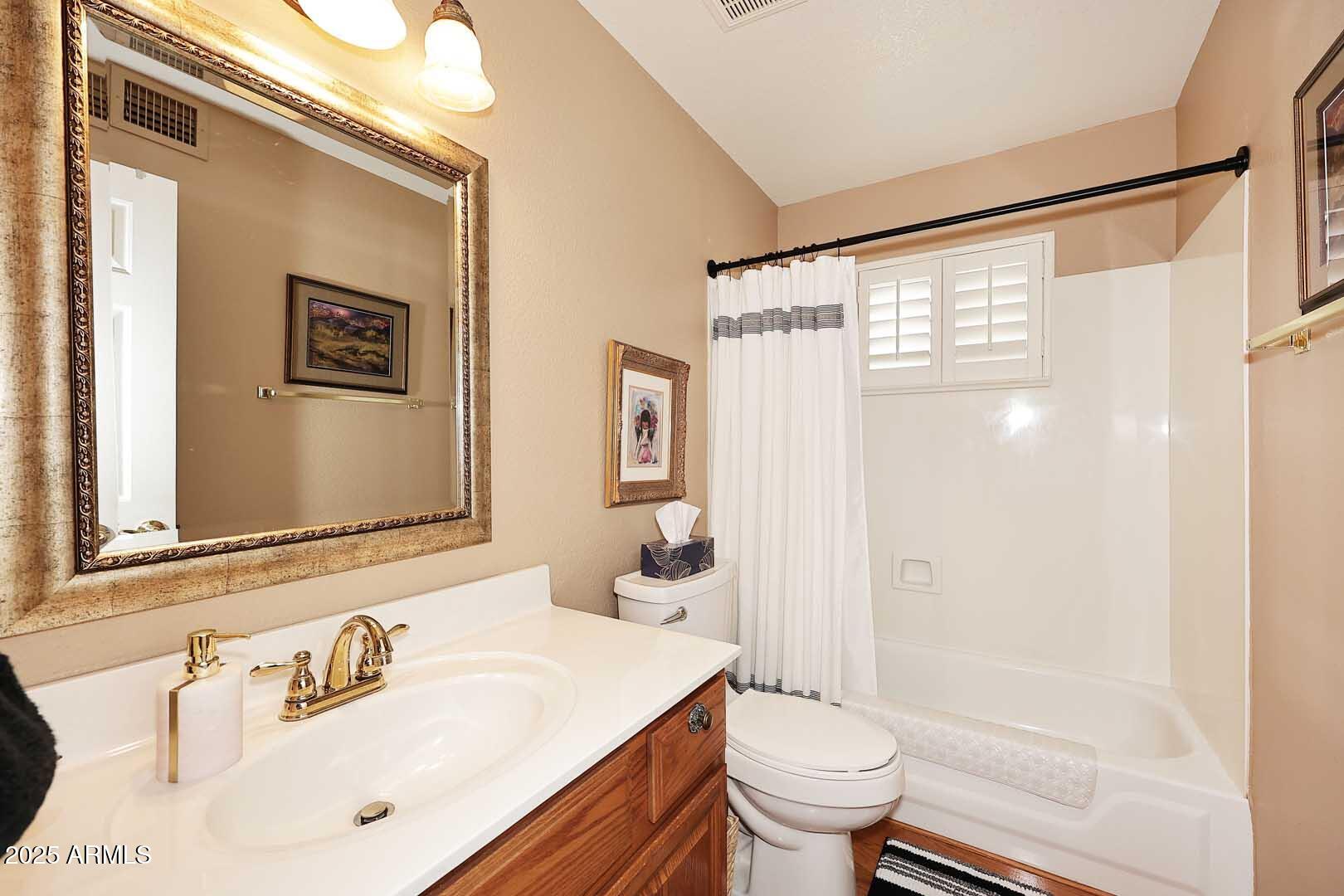 9025 West Marco Polo Road Peoria, AZ 85382 - Photo 21 of 38 a bathroom with a sink vanity mirror and toilet