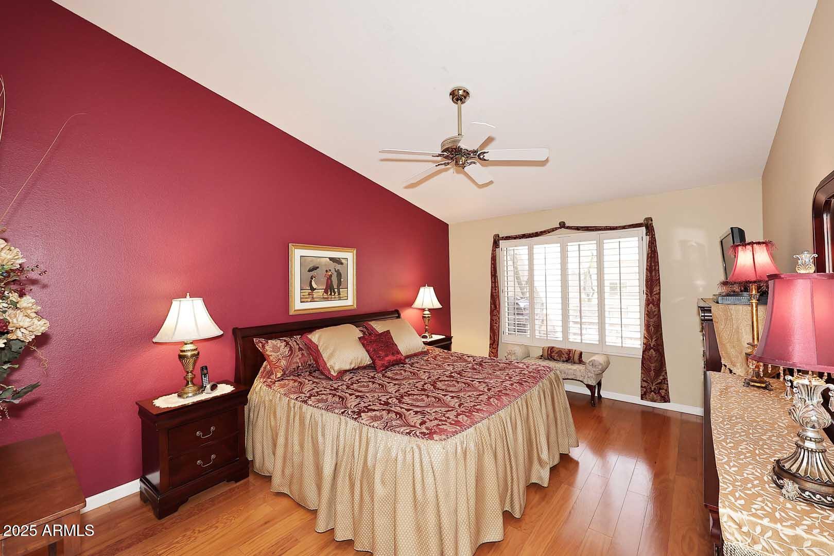 9025 West Marco Polo Road Peoria, AZ 85382 - Photo 22 of 38 a bedroom with a bed and wooden floor