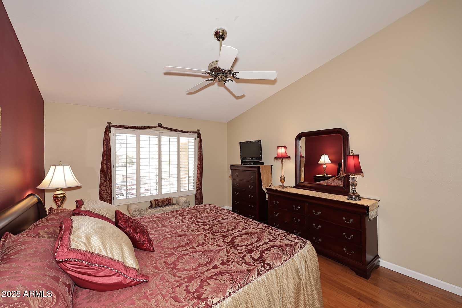 9025 West Marco Polo Road Peoria, AZ 85382 - Photo 23 of 38 a bedroom with a bed and wooden floor
