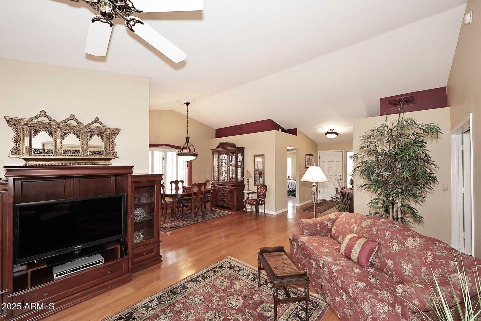 9025 West Marco Polo Road Peoria, AZ 85382 - Photo 9 of 38 a living room with furniture a flat screen tv and a fireplace