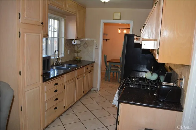 a kitchen with granite countertop a refrigerator and a stove