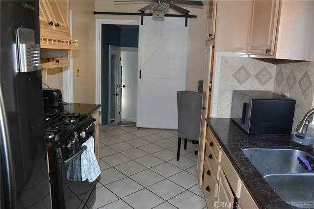 a kitchen with a refrigerator and a sink