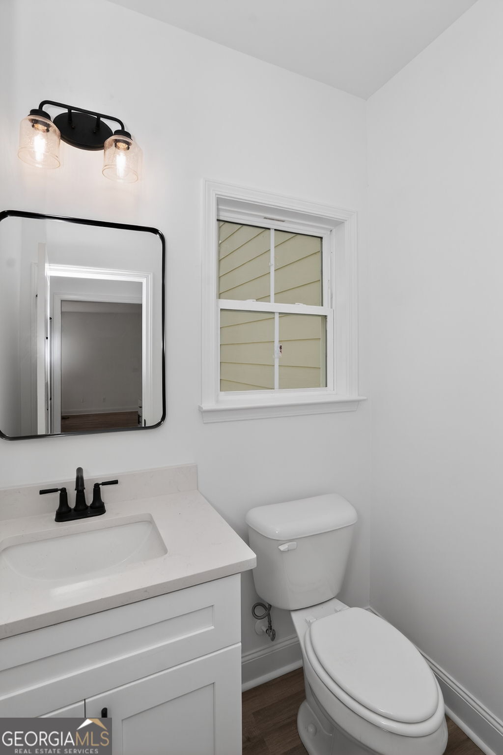 1229 Chappell Mill Road Jackson, GA 30233 - Photo 30 of 55 a bathroom with a toilet sink and mirror