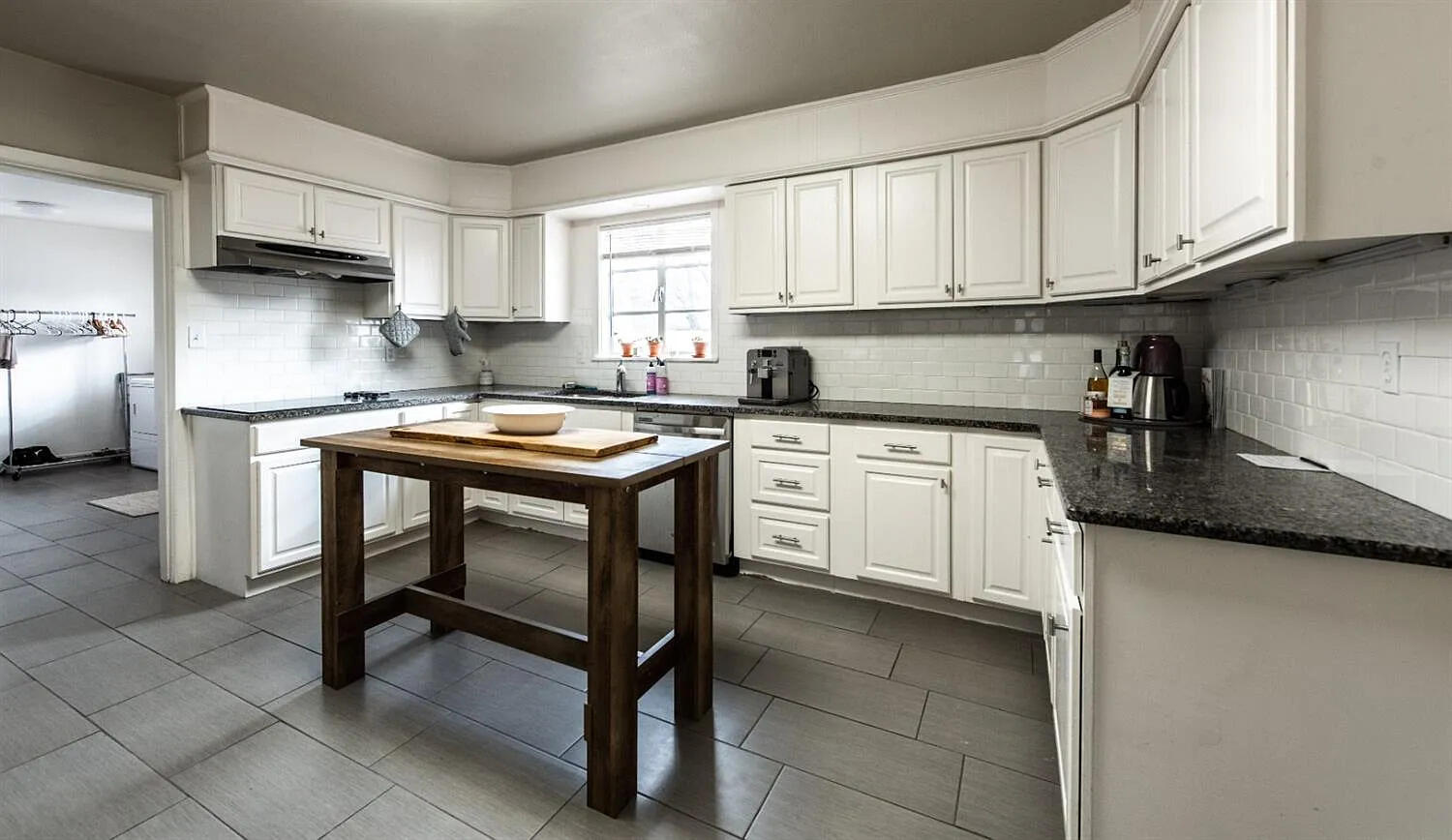 3105 29th Street Lubbock, TX 79410 - Photo 5 of 18 a kitchen with stainless steel appliances granite countertop a table chairs sink and cabinets