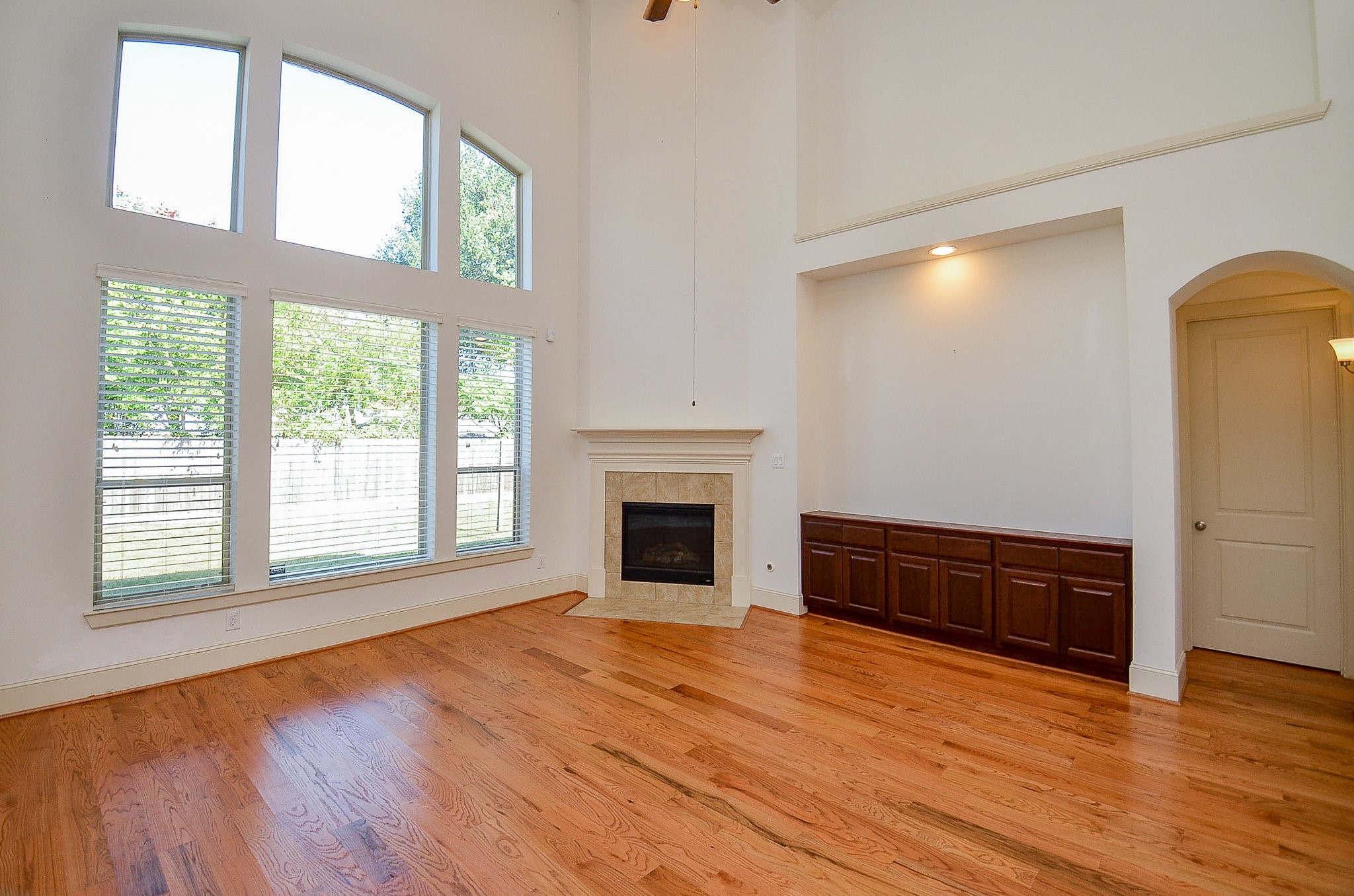 3302 Rochdale Street Houston, TX 77025 - Photo 13 of 49 a view of an empty room with wooden floor fireplace and a window