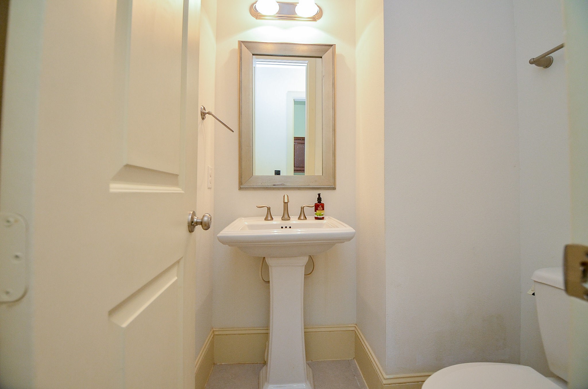 3302 Rochdale Street Houston, TX 77025 - Photo 18 of 49 a bathroom with a sink a toilet and mirror