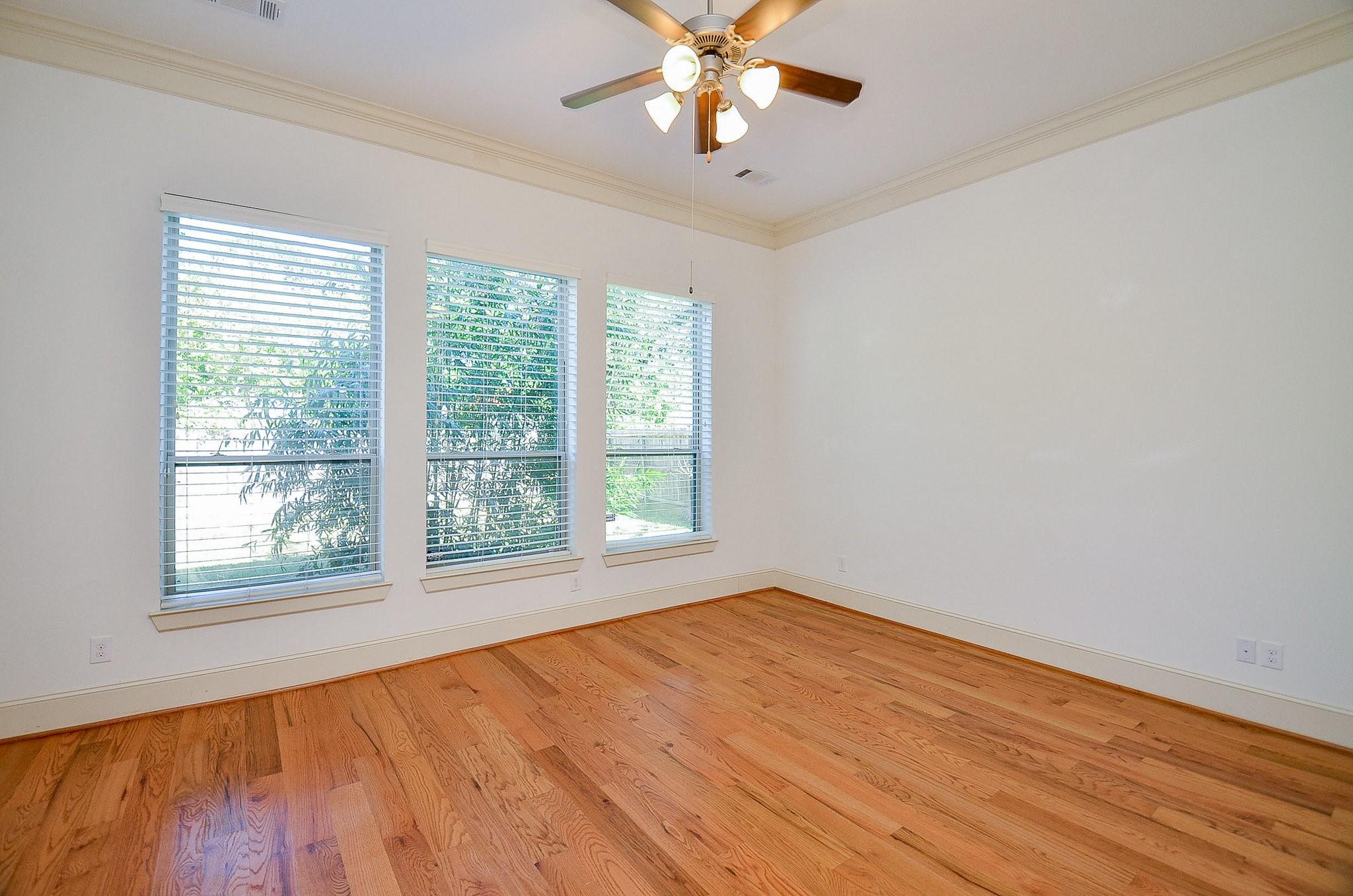 3302 Rochdale Street Houston, TX 77025 - Photo 19 of 49 a view of an empty room with wooden floor and a window