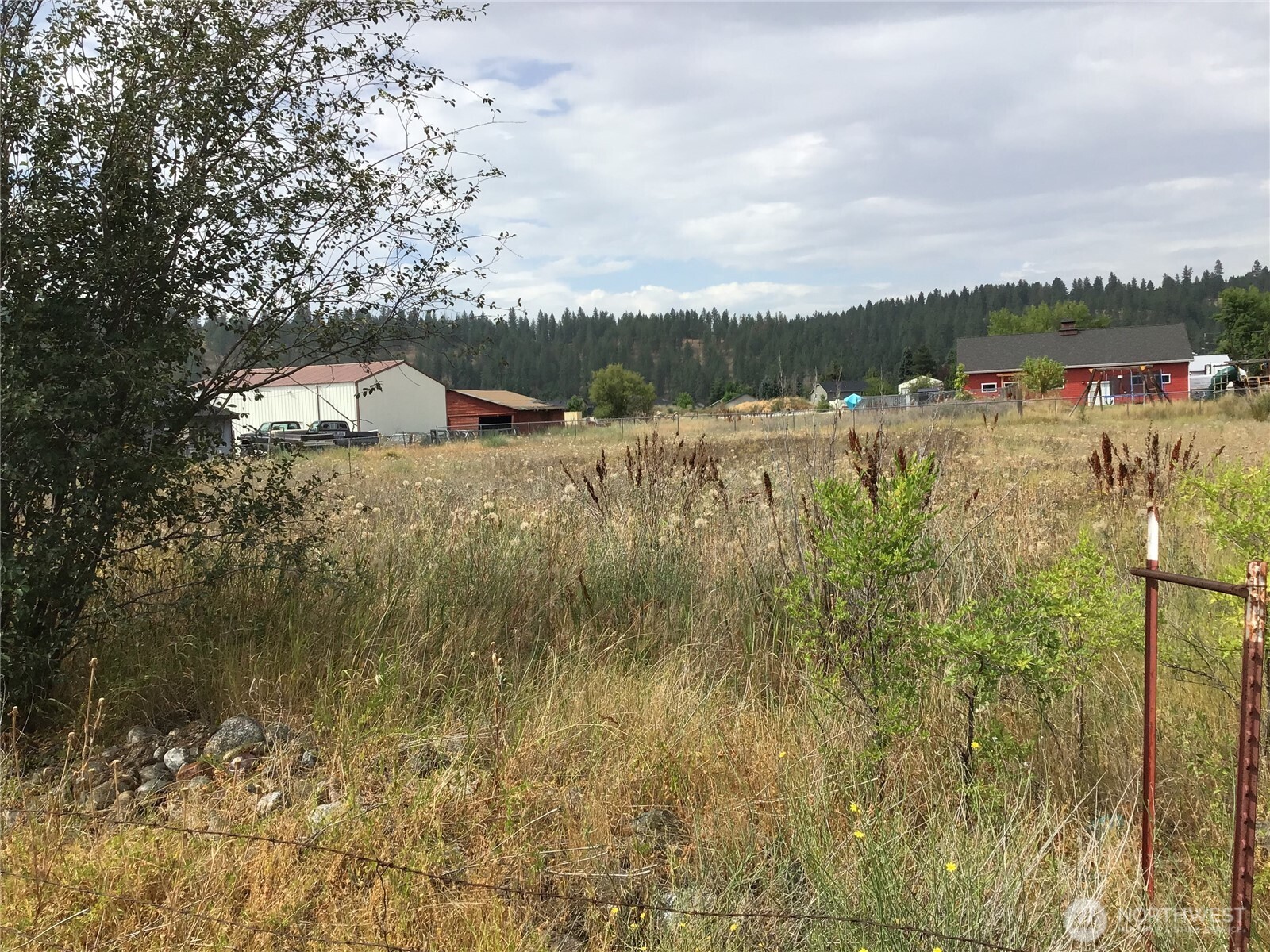 13007 East Wellesley Avenue Spokane Valley, WA 99216 - Photo 2 of 5 a view of a lake with houses in the back