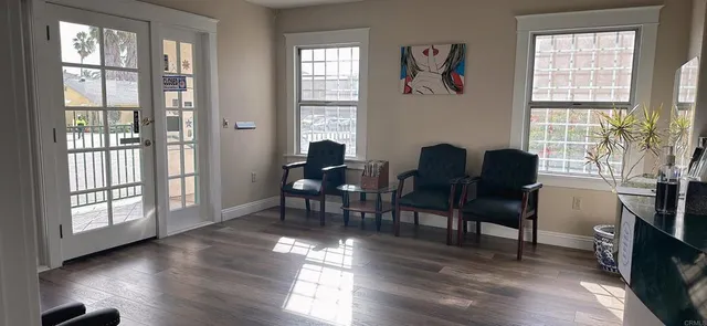 a workspace with wooden floor and a window