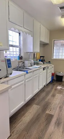 a kitchen with sink a stove and cabinets