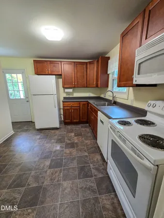 a kitchen with a stove a sink and a refrigerator