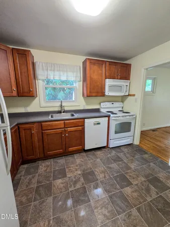 a kitchen with a cabinets a sink and appliances