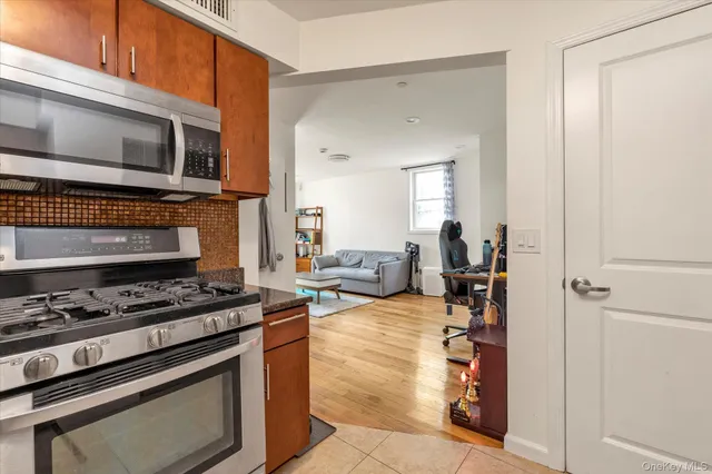 a kitchen with stainless steel appliances a stove a microwave and a counter top space