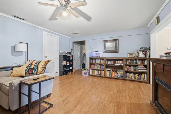 a living room with furniture and wooden floor