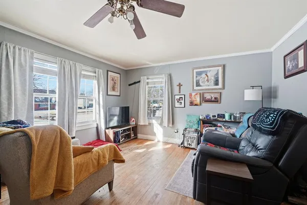 a living room with furniture a large window and a flat screen tv