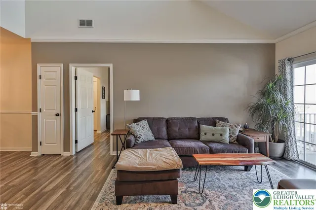 a view of a dining room with furniture wooden floor and a chandelier