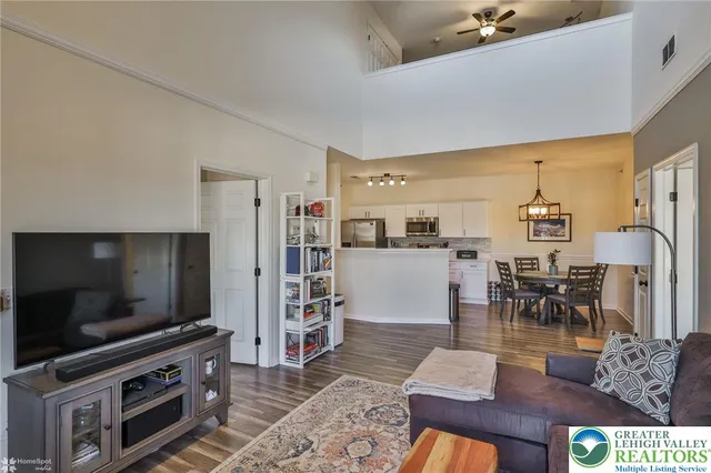 a kitchen with stainless steel appliances granite countertop a stove refrigerator sink and microwave