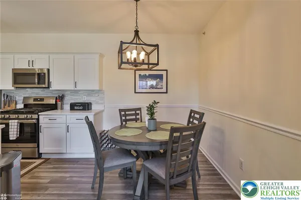 a kitchen with stainless steel appliances a sink a stove and cabinets