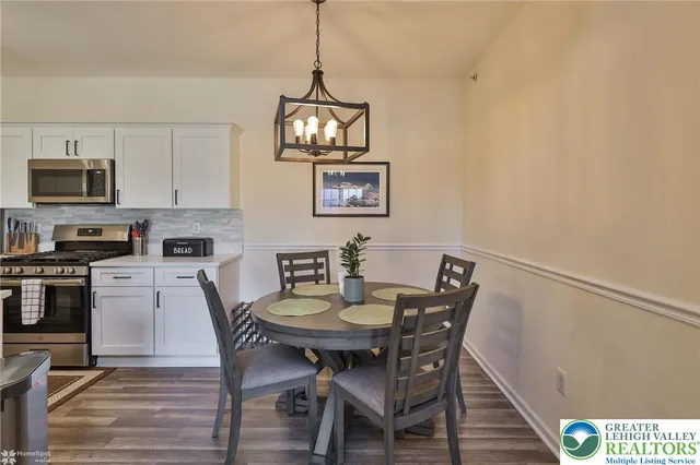 a kitchen with stainless steel appliances a sink a stove and cabinets