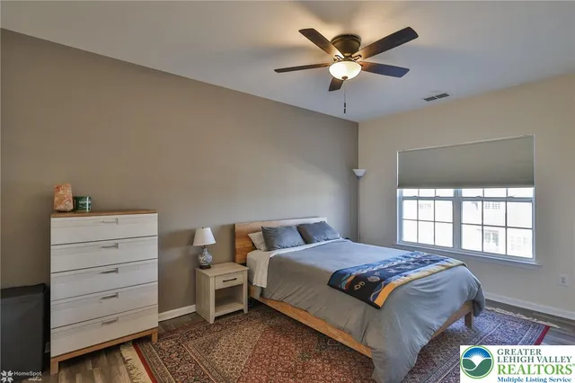 an aerial view of a city with lots of residential buildings ocean and mountain view in back