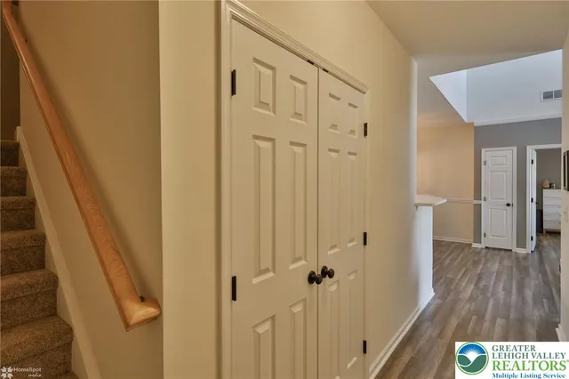 a living room with furniture and a book shelf