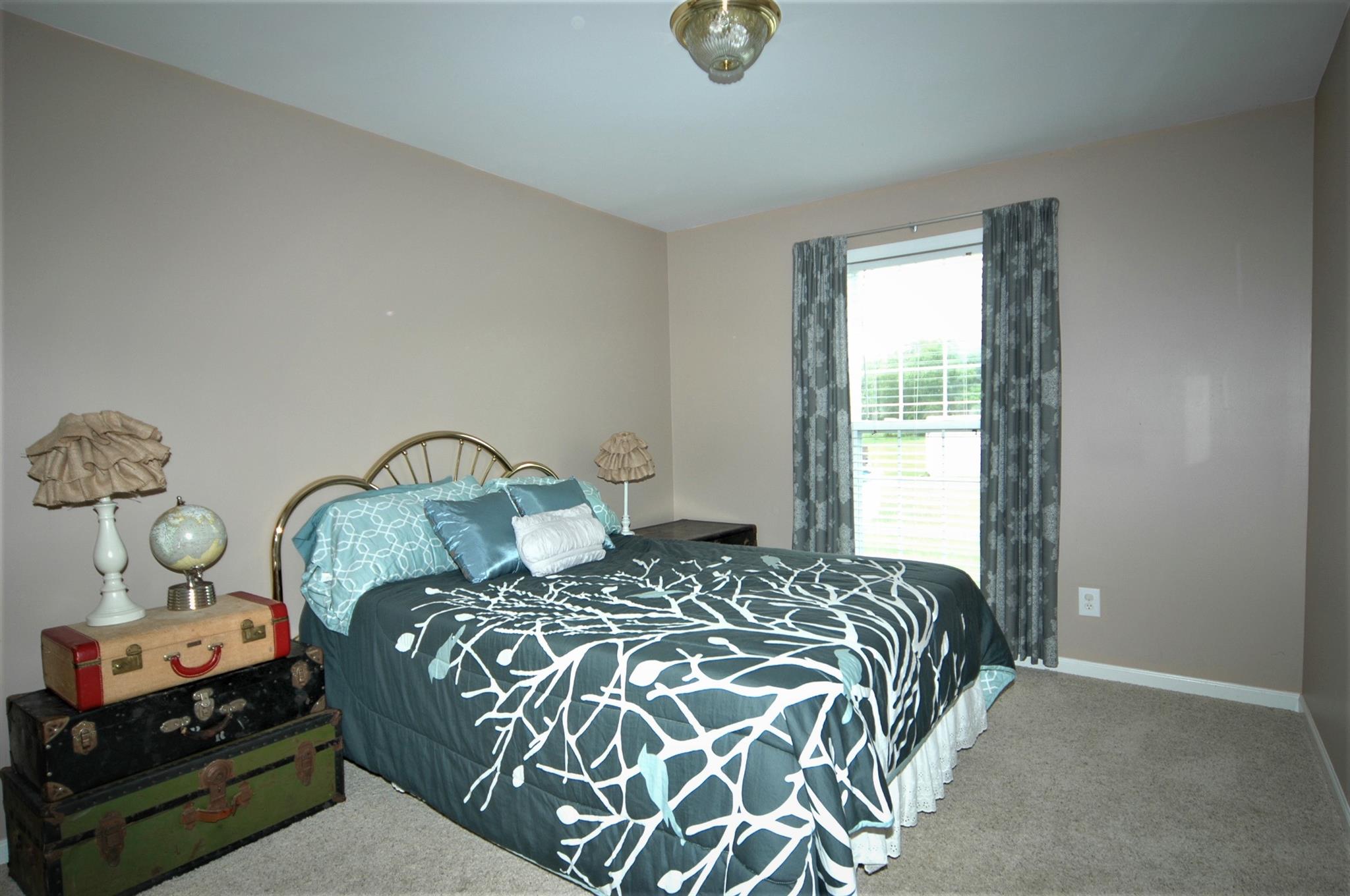 1961 Lasea Road Spring Hill, TN 37174 - Photo 12 of 18 a bedroom with a bed and a window