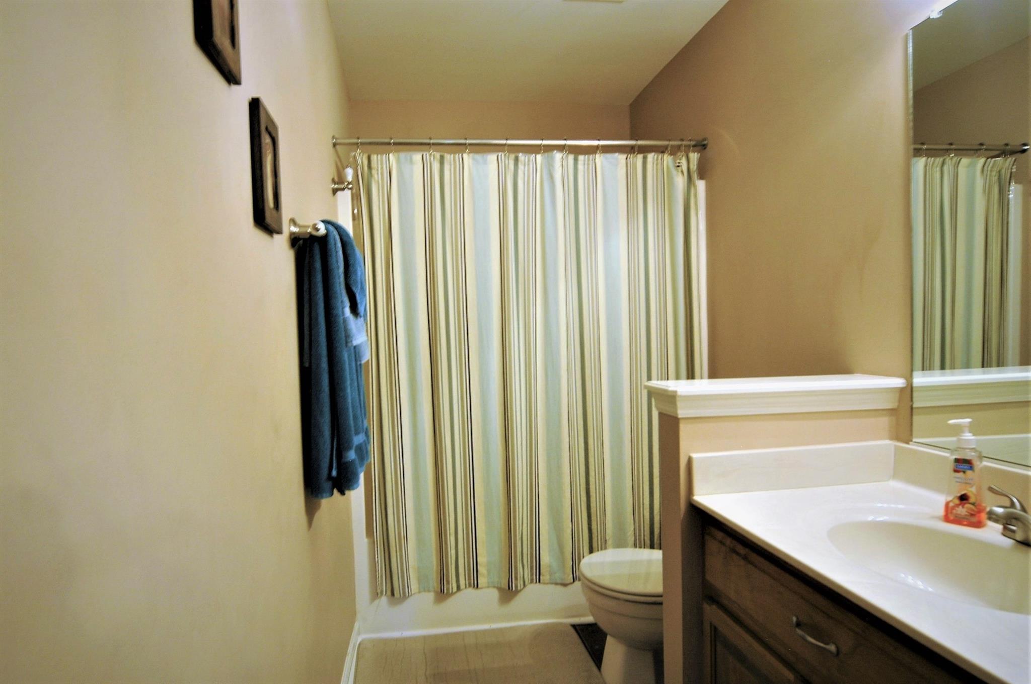 1961 Lasea Road Spring Hill, TN 37174 - Photo 13 of 18 a bathroom with a sink a toilet and shower