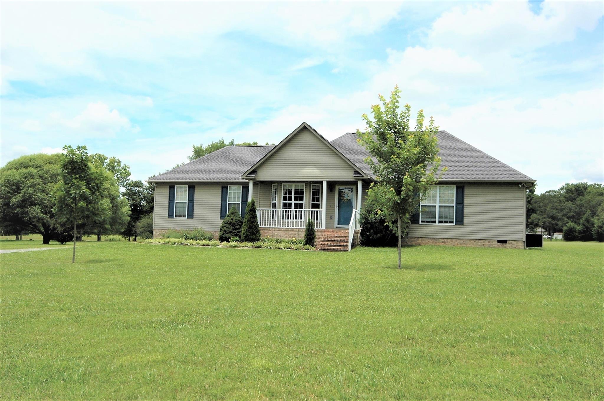 1961 Lasea Road Spring Hill, TN 37174 - Photo 3 of 18 a front view of a house with a garden and porch
