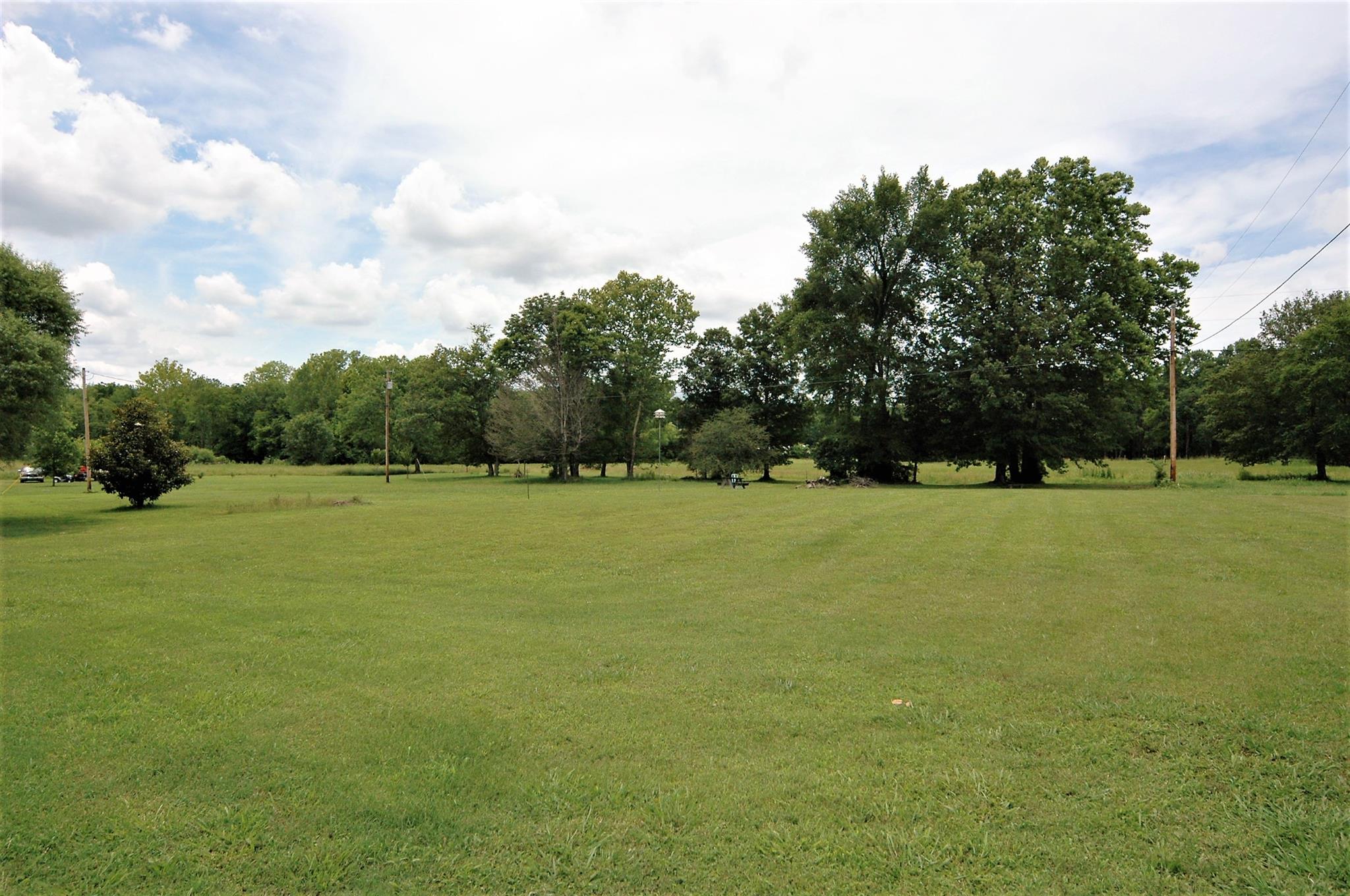 1961 Lasea Road Spring Hill, TN 37174 - Photo 6 of 18 a view of a green field with wooden fence