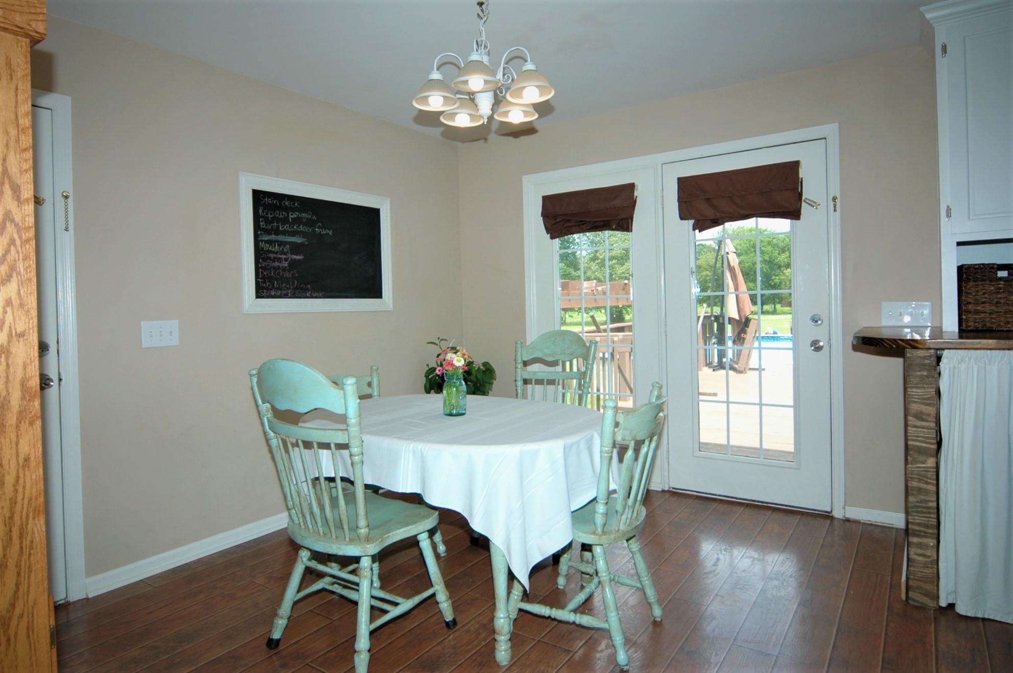 1961 Lasea Road Spring Hill, TN 37174 - Photo 7 of 18 a view of a dining room with furniture window and wooden floor