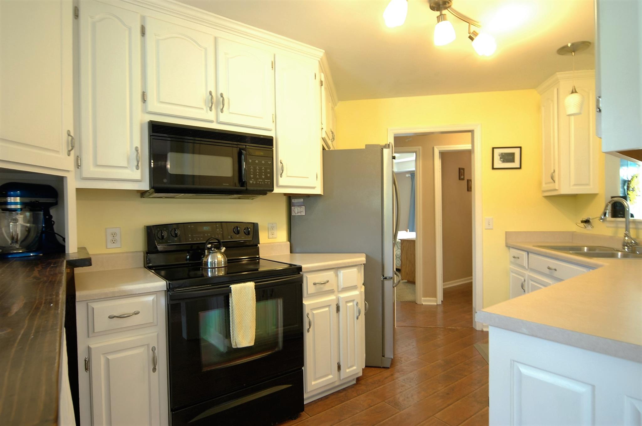 1961 Lasea Road Spring Hill, TN 37174 - Photo 8 of 18 a kitchen with stainless steel appliances granite countertop a stove microwave and refrigerator
