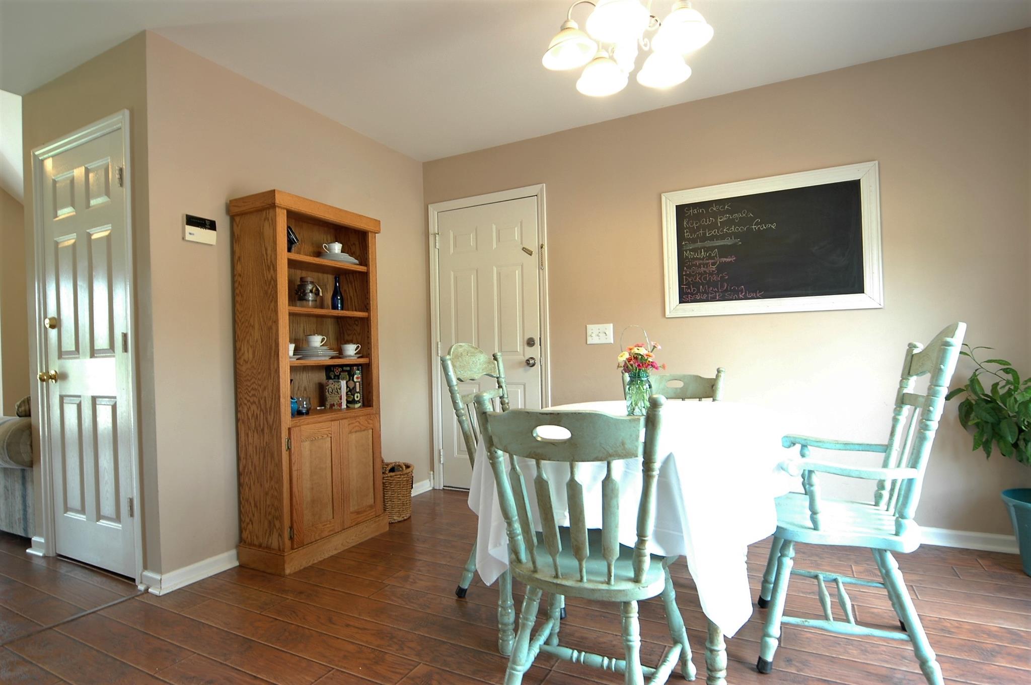 1961 Lasea Road Spring Hill, TN 37174 - Photo 9 of 18 a view of a dining room with furniture and wooden floor
