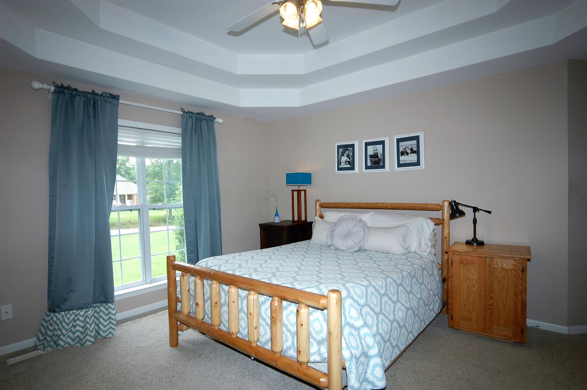 1961 Lasea Road Spring Hill, TN 37174 - Photo 10 of 18 a bedroom with a bed and a chandelier