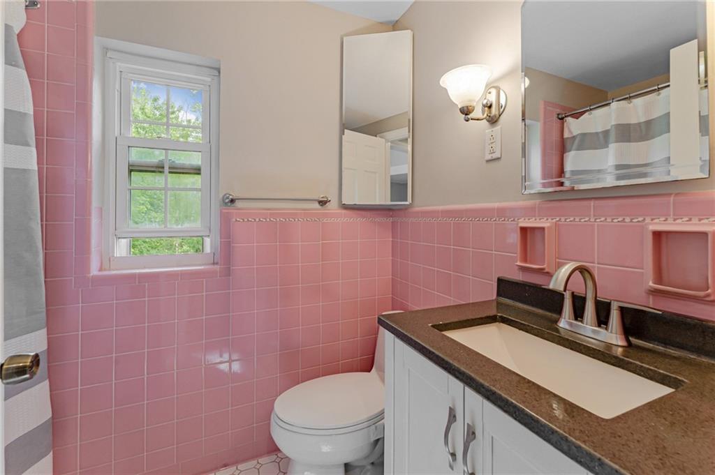 116 Elmore Road Pittsburgh, PA 15221 - Photo 12 of 16 a bathroom with a granite countertop toilet sink and mirror