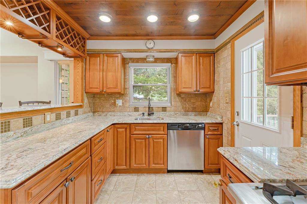 116 Elmore Road Pittsburgh, PA 15221 - Photo 6 of 16 a kitchen with a sink stove and cabinets