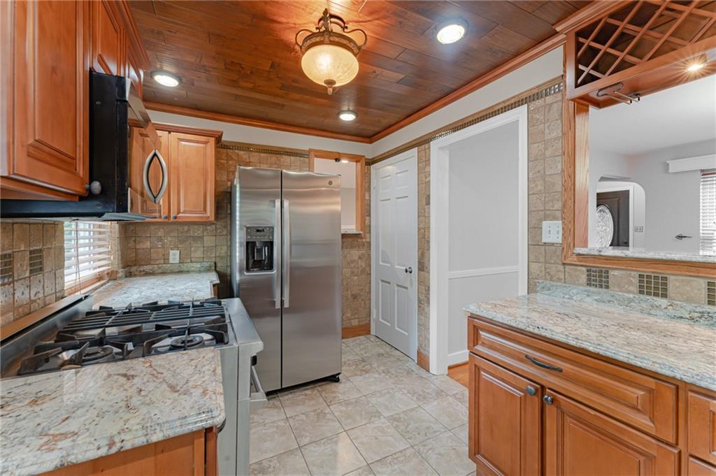 116 Elmore Road Pittsburgh, PA 15221 - Photo 8 of 16 a kitchen with stainless steel appliances granite countertop a refrigerator and a sink