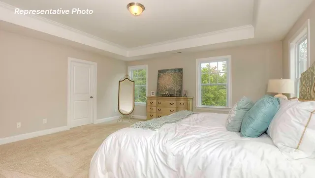 a spacious bedroom with a bed and a large window