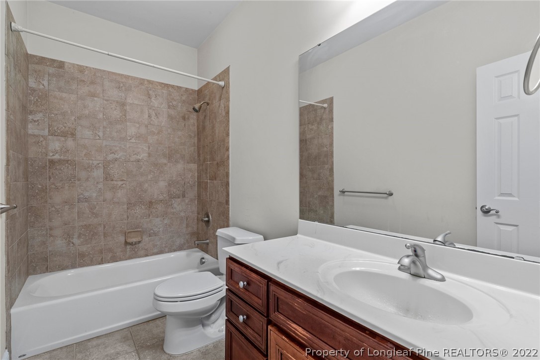287 Falling Water Road Spring Lake, NC 28390 - Photo 13 of 24 a bathroom with a sink a toilet a bathtub and shower