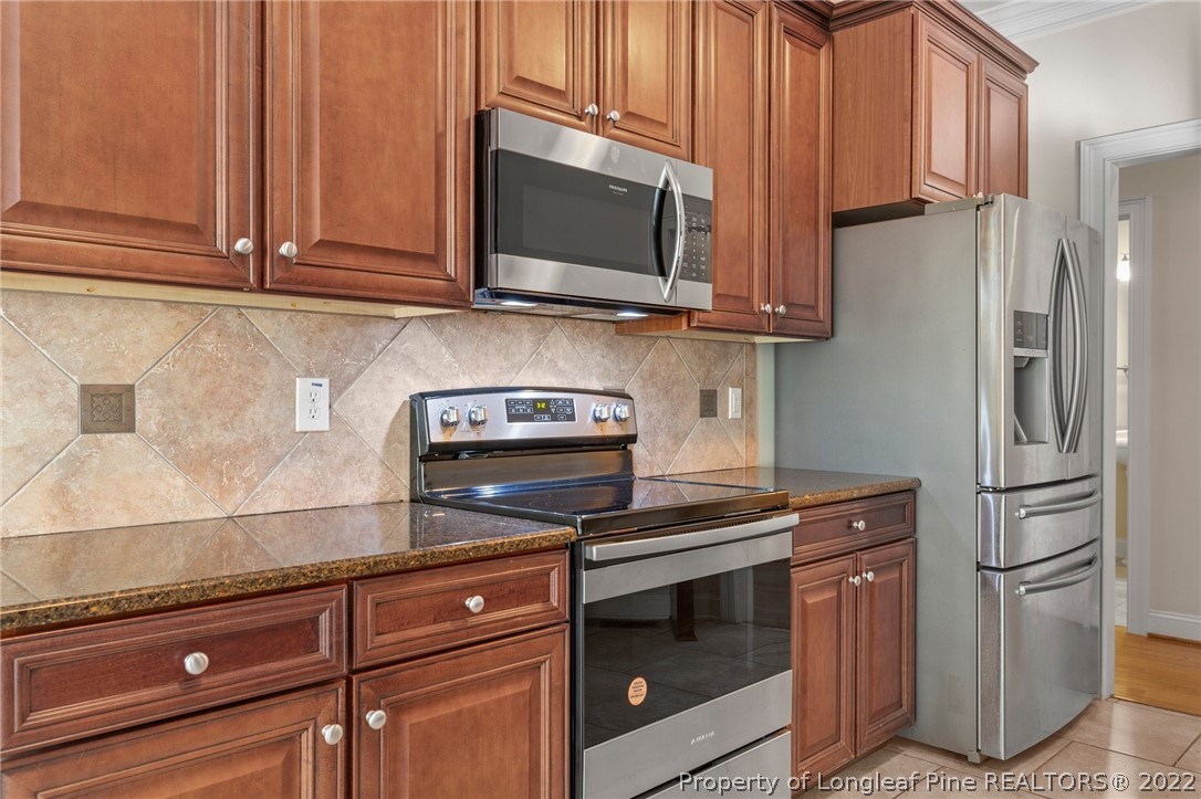 287 Falling Water Road Spring Lake, NC 28390 - Photo 3 of 24 a kitchen with stainless steel appliances granite countertop a refrigerator stove and microwave