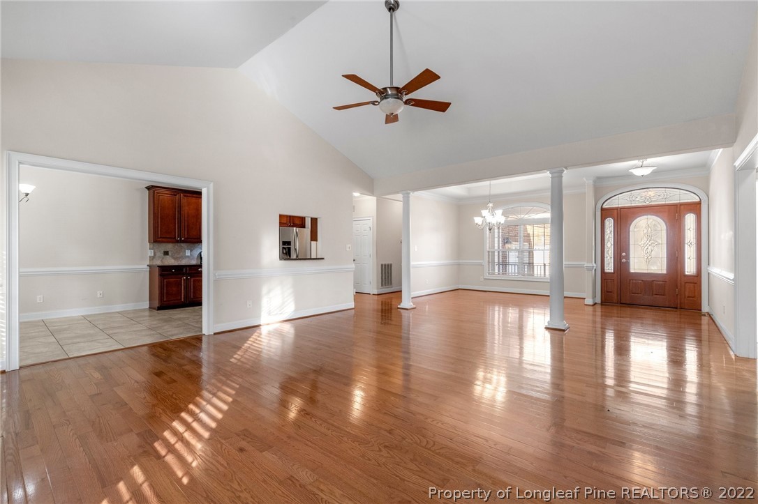 287 Falling Water Road Spring Lake, NC 28390 - Photo 7 of 24 a view of a livingroom with wooden floor a ceiling fan and windows