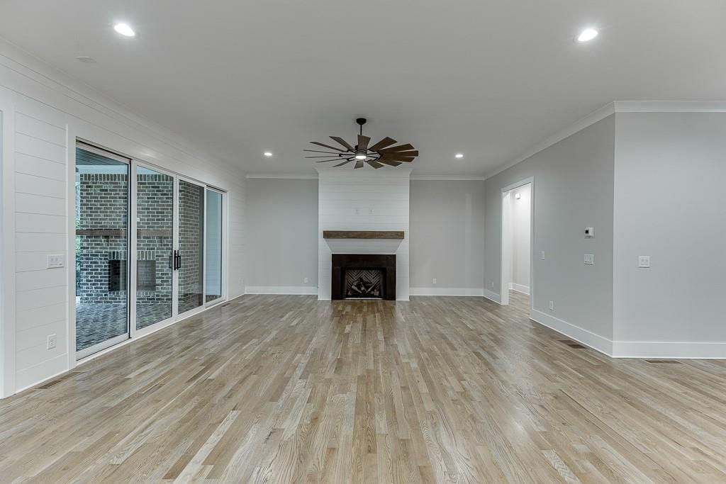7620 Breeze Bay Road Cumming, GA 30041 - Photo 11 of 53 a view of an empty room with a fireplace and a window