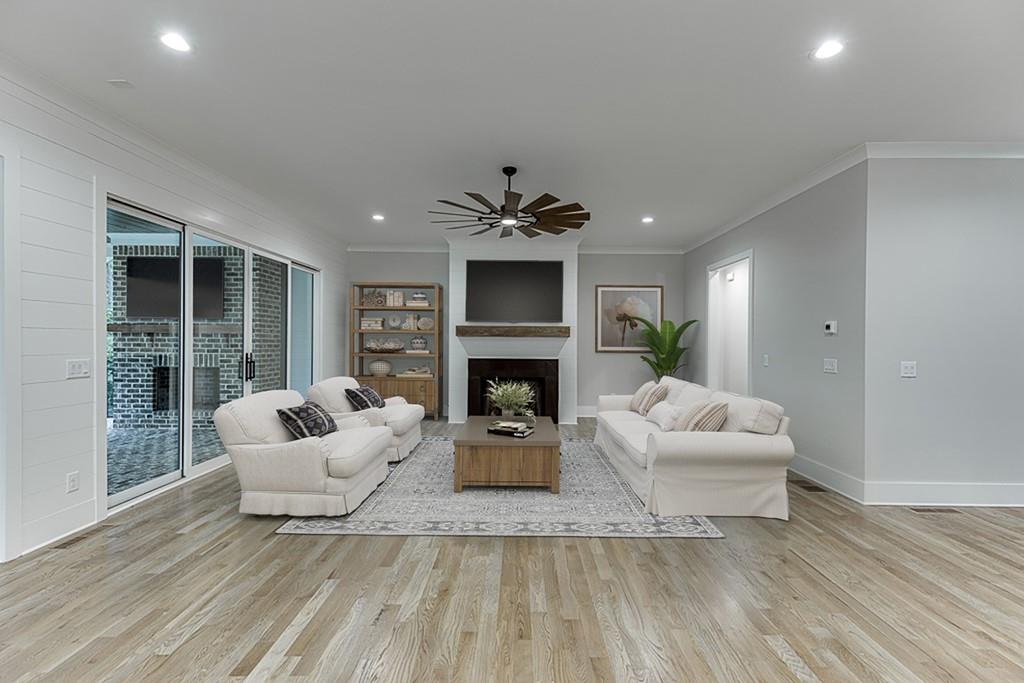 7620 Breeze Bay Road Cumming, GA 30041 - Photo 12 of 53 a living room with furniture and a fireplace