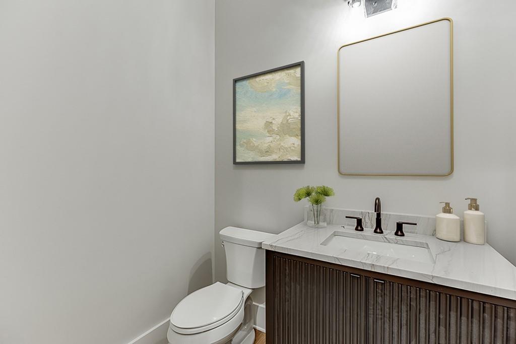 7620 Breeze Bay Road Cumming, GA 30041 - Photo 15 of 53 a bathroom with a sink a toilet and mirror