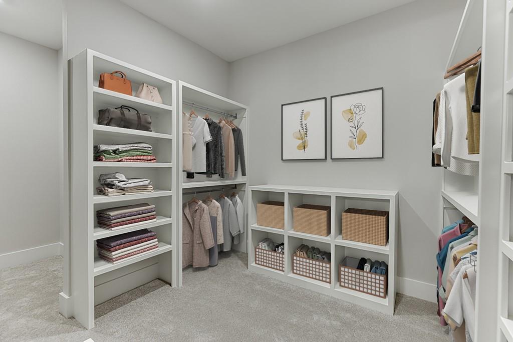 7620 Breeze Bay Road Cumming, GA 30041 - Photo 19 of 53 a view of walk in closet with clothes and shoes